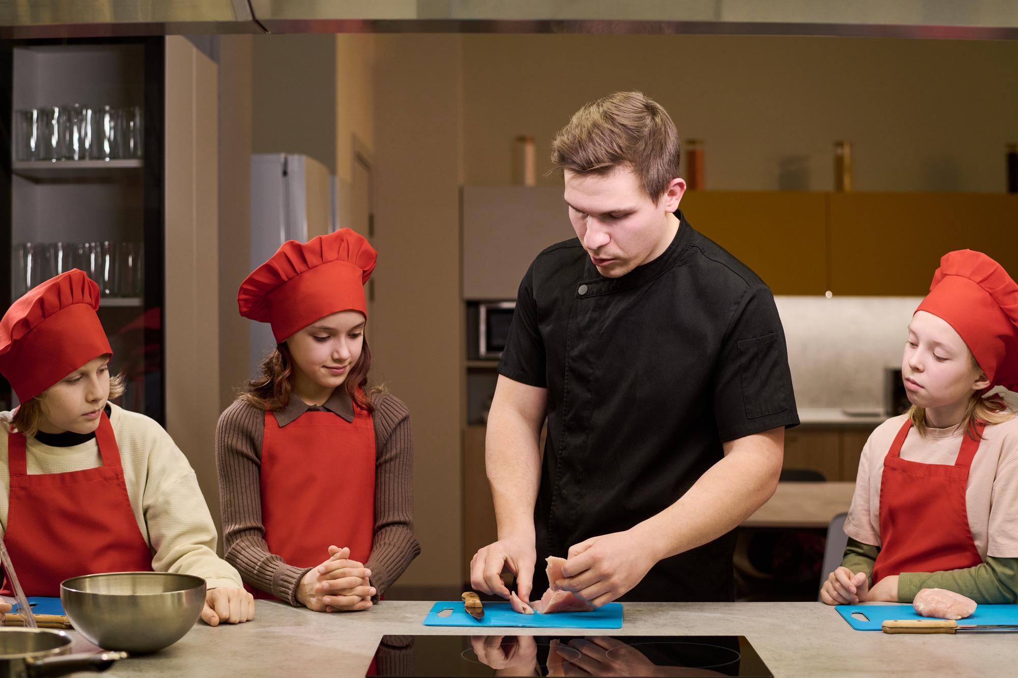 Chef demonstrating technique to students